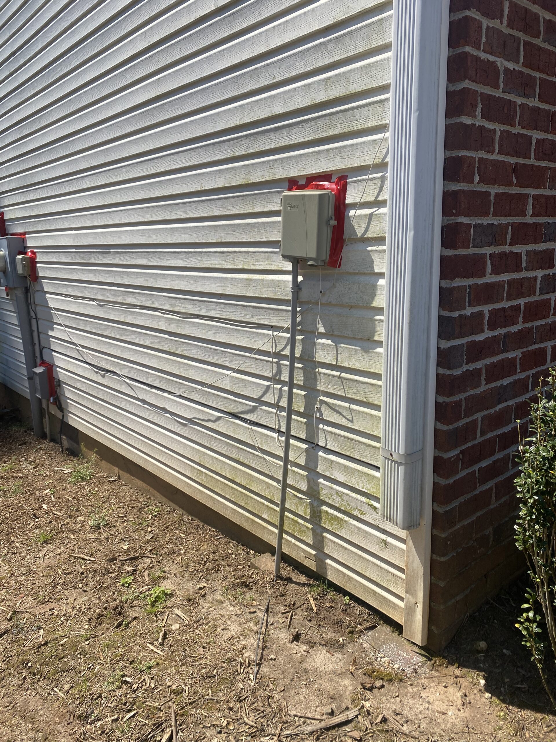 Vinyl sided house corner with utility boxes