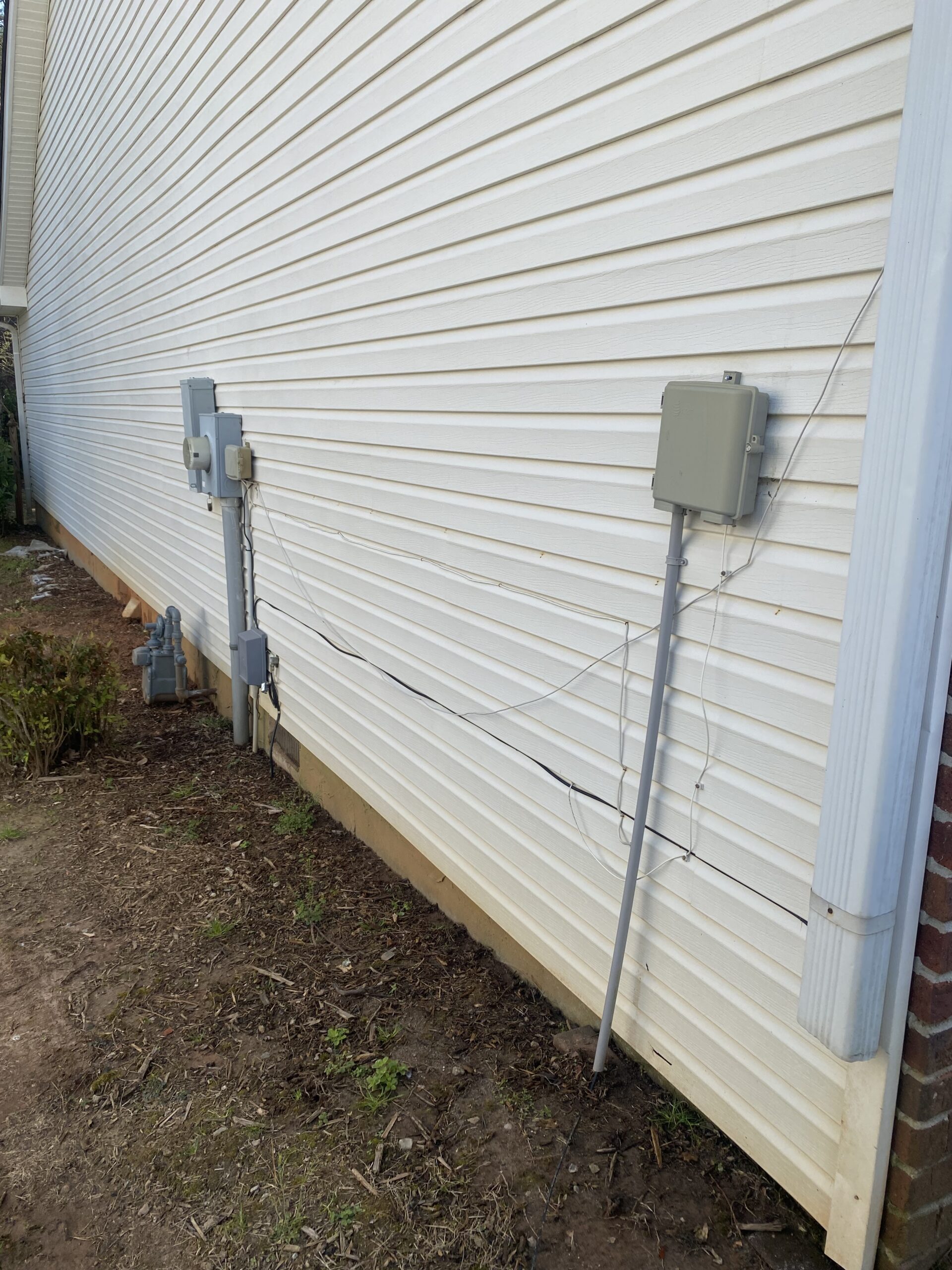 White vinyl siding with utility boxes