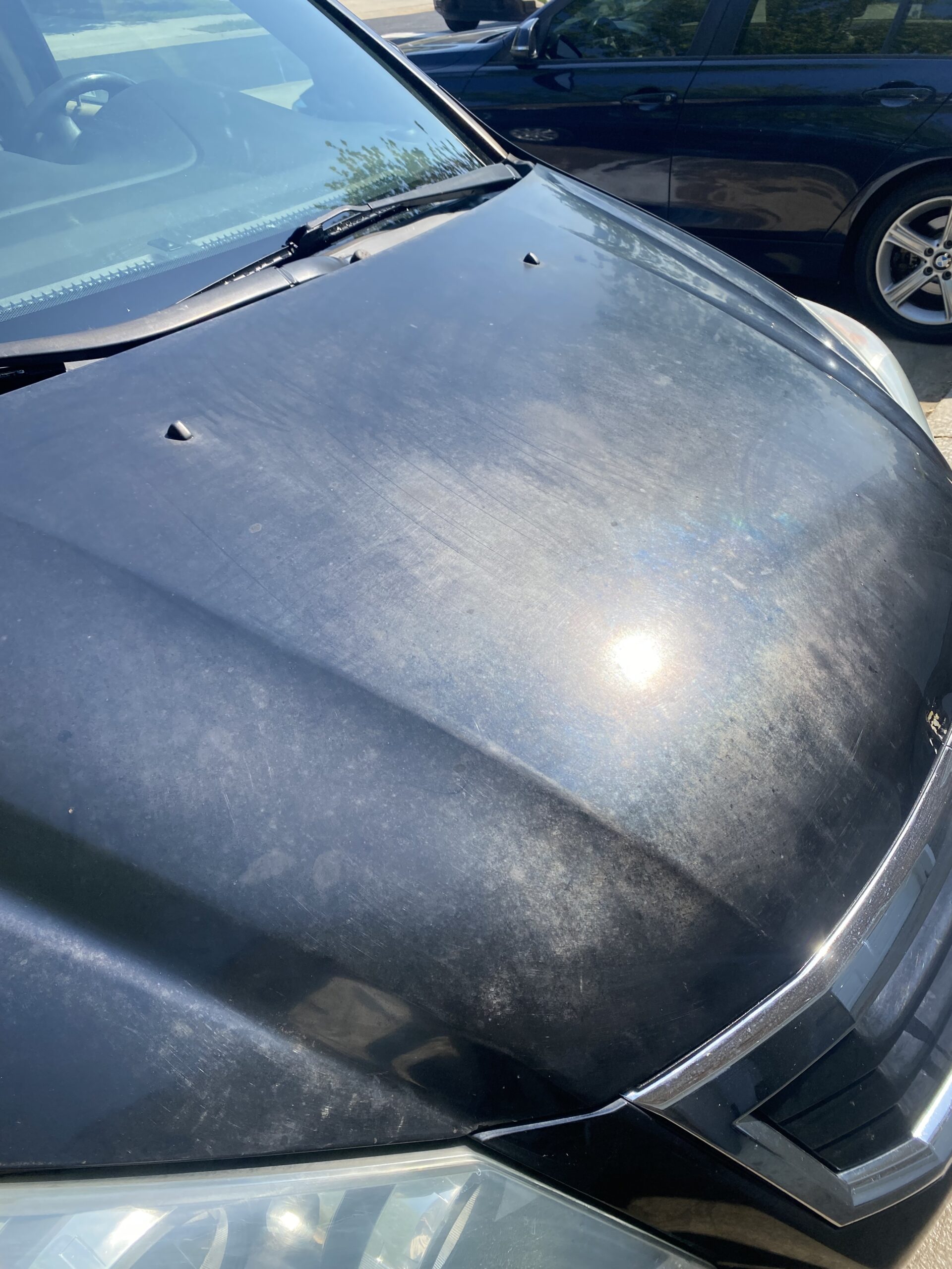 Faded car hood with sun glare