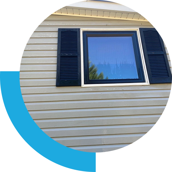 Beige vinyl siding with window and black shutters