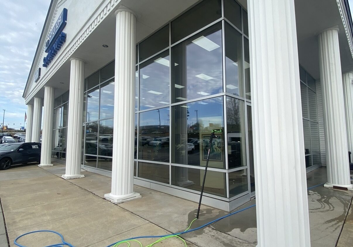 Glass storefront flanked by white columns