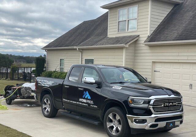 Black Hydro Pros RAM truck towing pressure washer