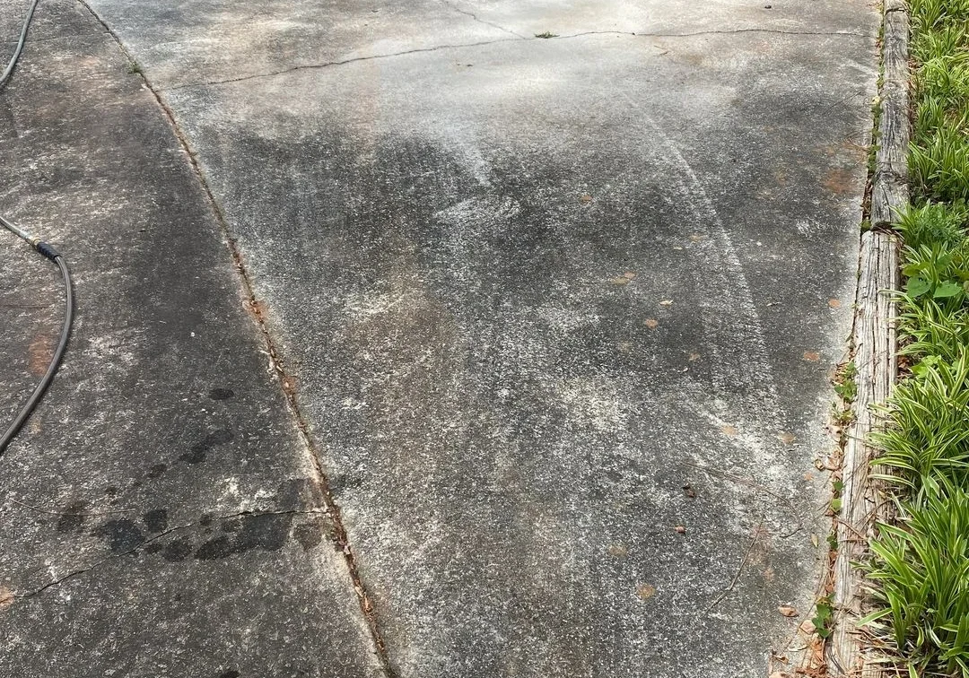Pressure washing concrete driveway with yellow surface cleaner